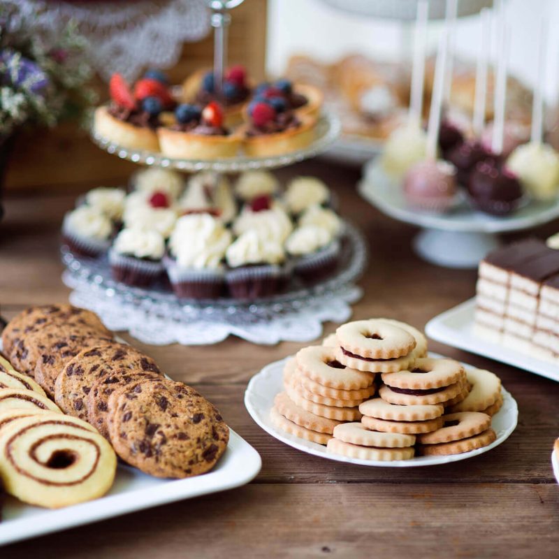 table-with-various-cookies-tarts-cakesxc-cupcakes-an-PARM8L9.jpg